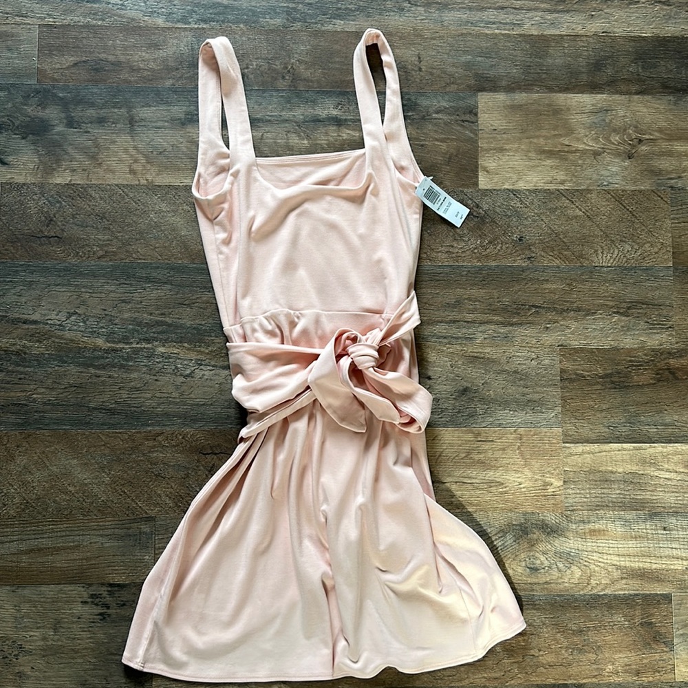 This is a mini wrap dress with a side tie and double square neckline.